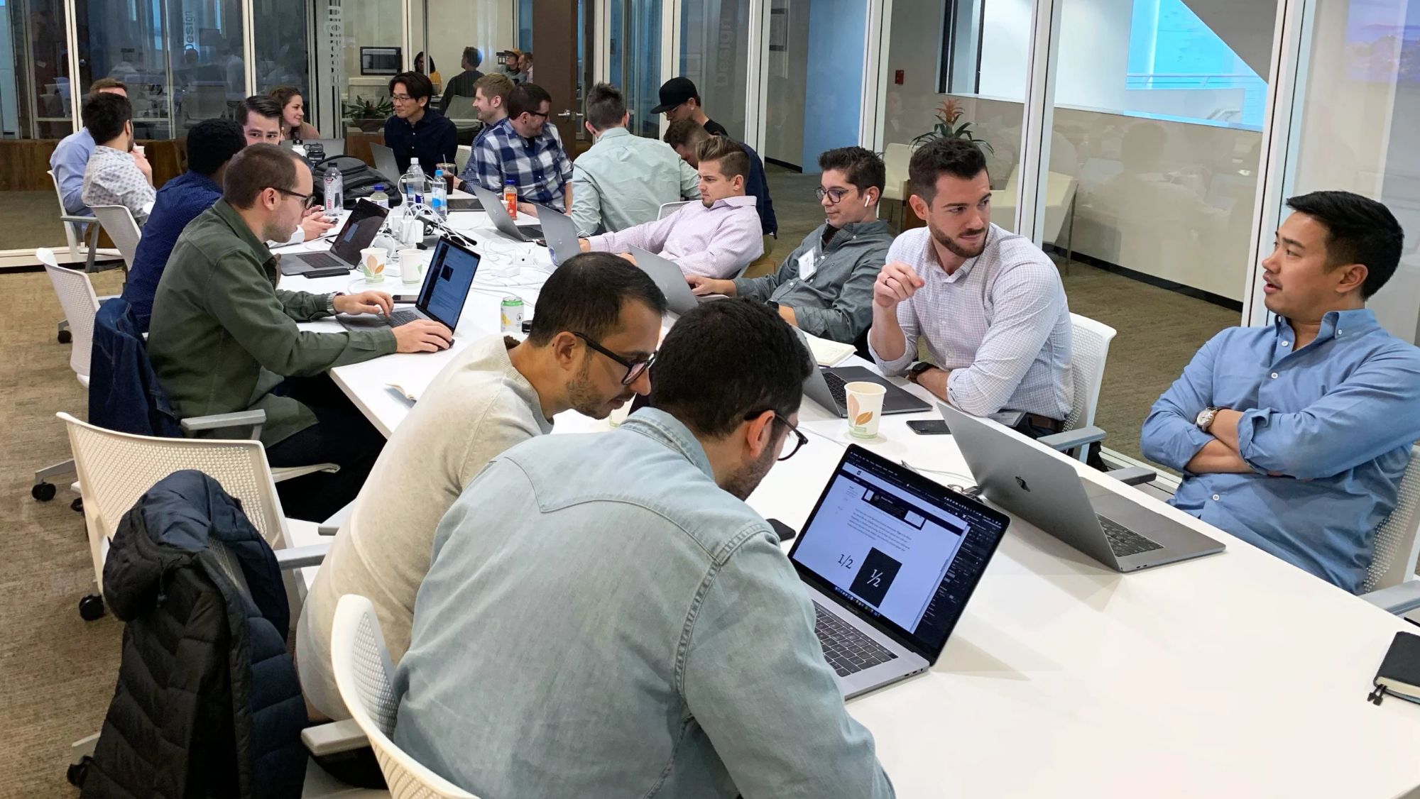 Nagarro and RMS team working together at a long table with laptops